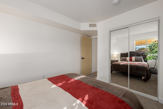 bedroom with carpet floors and a closet