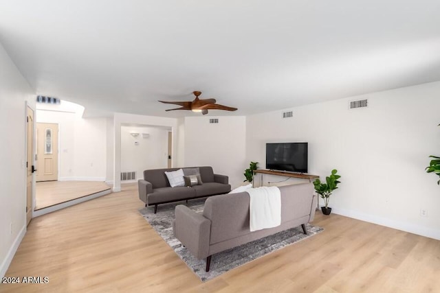 living room featuring light hardwood / wood-style flooring and ceiling fan