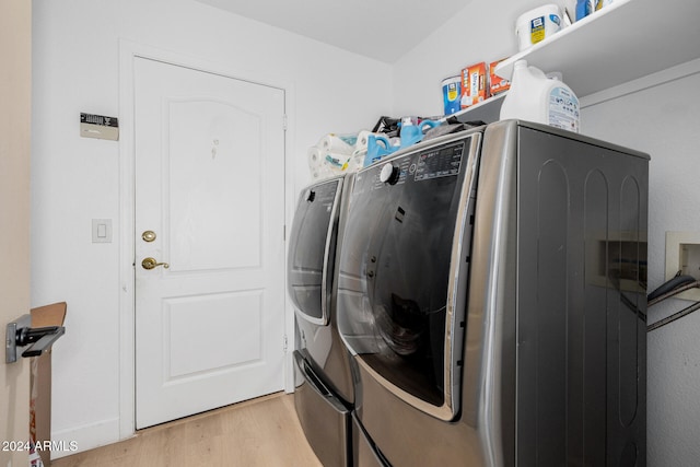 washroom featuring light hardwood / wood-style floors and washer and clothes dryer