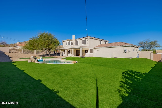 rear view of property with a yard