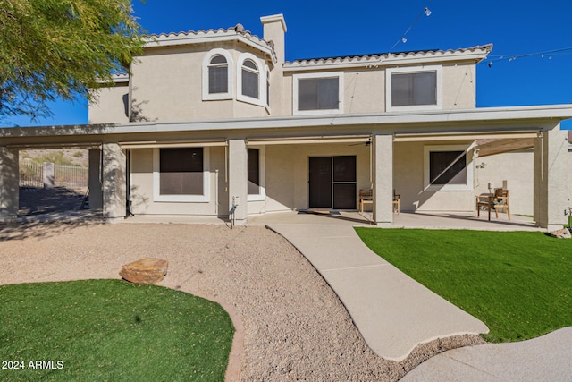 view of front of home featuring a front yard and a patio area