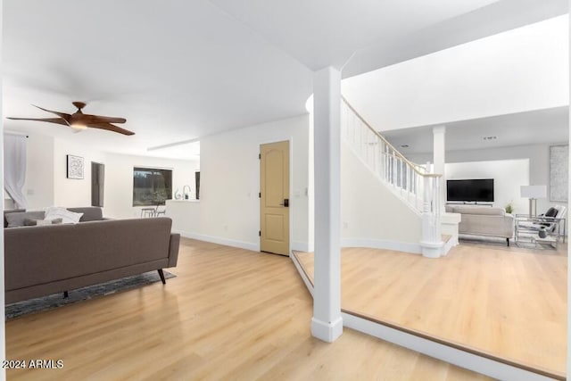 living room with hardwood / wood-style flooring and ceiling fan