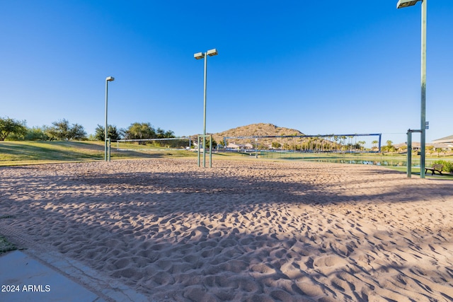 view of property's community with volleyball court and a mountain view