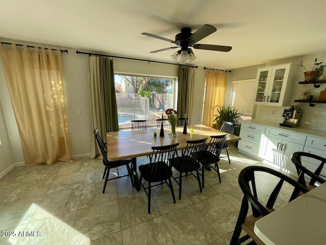 dining room featuring ceiling fan and baseboards