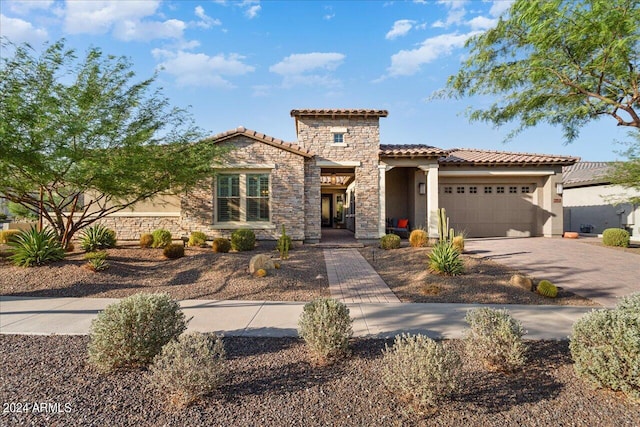 mediterranean / spanish home with a garage