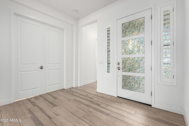 foyer entrance with light hardwood / wood-style flooring