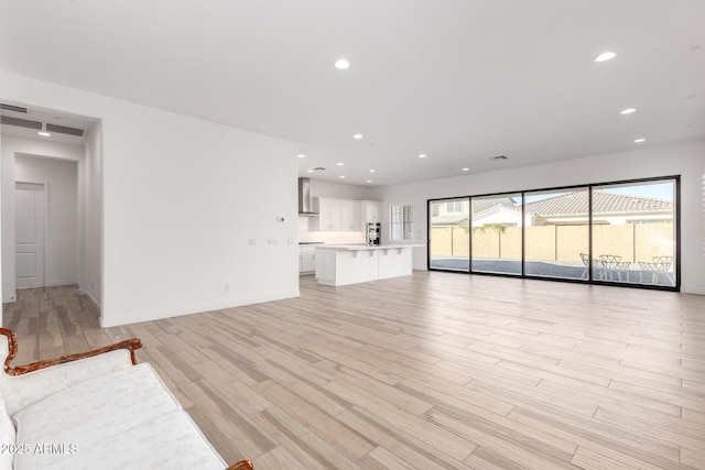 unfurnished living room with light hardwood / wood-style floors