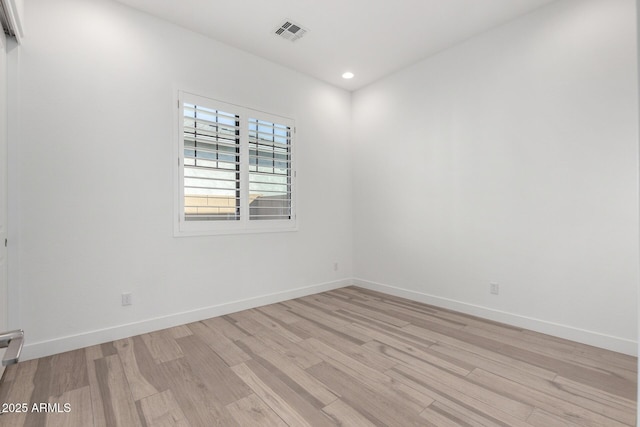 spare room with light wood-type flooring