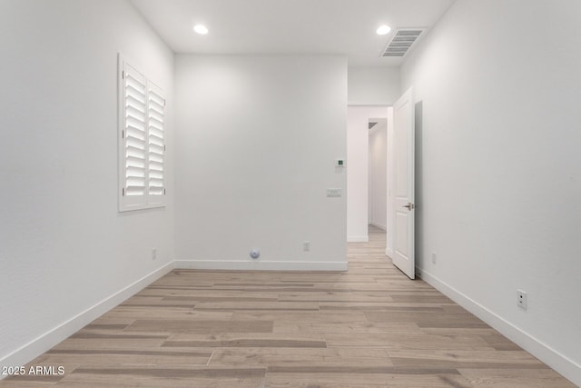 unfurnished room with light wood-type flooring