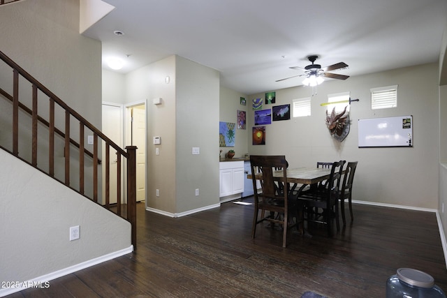 dining space featuring dark wood-type flooring, baseboards, ceiling fan, and stairway