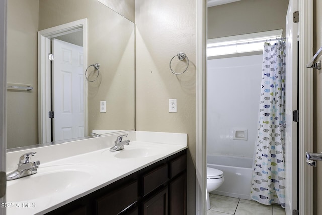 full bath featuring tile patterned flooring, shower / tub combo with curtain, double vanity, toilet, and a sink