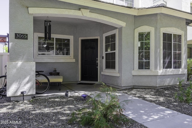 view of exterior entry featuring stucco siding