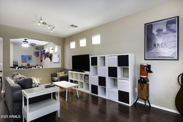 living area with visible vents, baseboards, ceiling fan, and wood finished floors