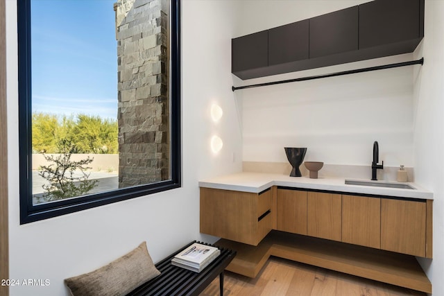 office space featuring a sink and light wood finished floors