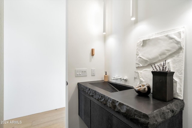 bathroom with wood finished floors and vanity