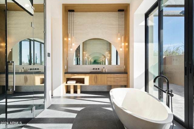 full bathroom with a freestanding tub and vanity