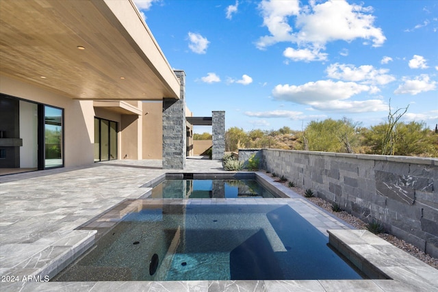 view of pool featuring a fenced in pool, a patio area, and an in ground hot tub