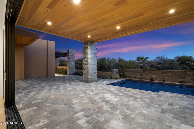 view of pool at dusk