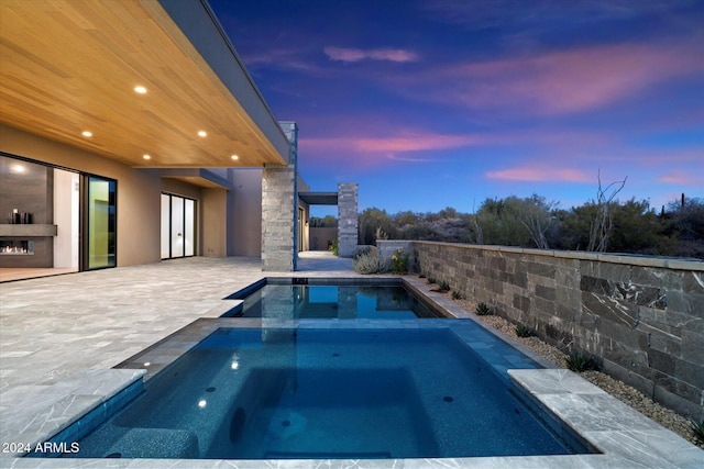 view of swimming pool with a patio area and a pool with connected hot tub