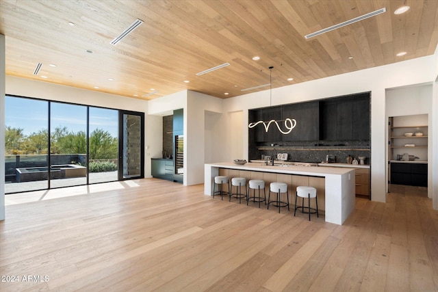 bar featuring light wood finished floors, recessed lighting, decorative backsplash, a sink, and wooden ceiling