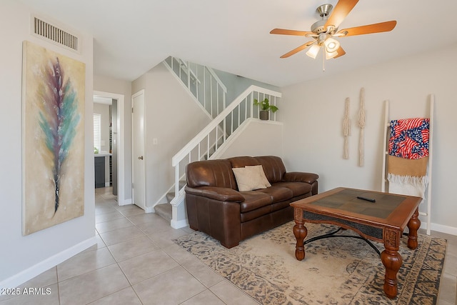 2455 E Broadway Rd Unit 115, Mesa, AZ 85204 - living area with stairway, baseboards, ceiling fan, and light tile patterned floors