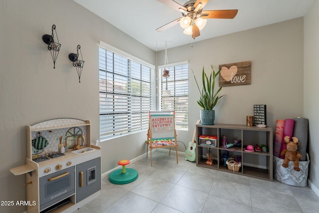 2455 E Broadway Rd Unit 115, Mesa, AZ 85204 - sitting room with a ceiling fan, baseboards, and light tile patterned flooring