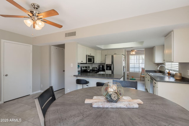 2455 E Broadway Rd Unit 115, Mesa, AZ 85204 - dining area featuring a ceiling fan, light tile patterned flooring, and baseboards