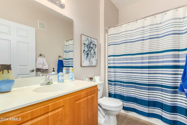 bathroom featuring tile patterned flooring, vanity, and toilet