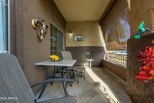 view of patio featuring a balcony