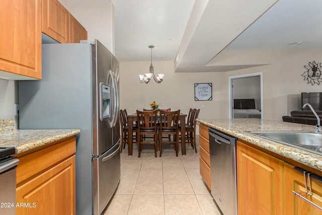 kitchen featuring sink, appliances with stainless steel finishes, decorative light fixtures, light tile patterned flooring, and a chandelier