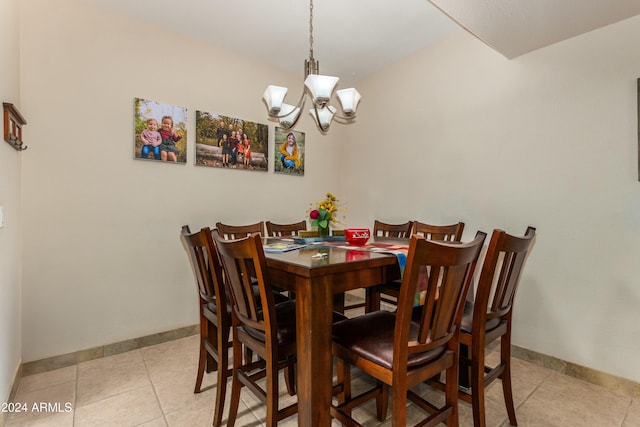 tiled dining space featuring an inviting chandelier