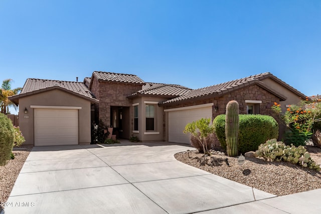 mediterranean / spanish-style home with a garage