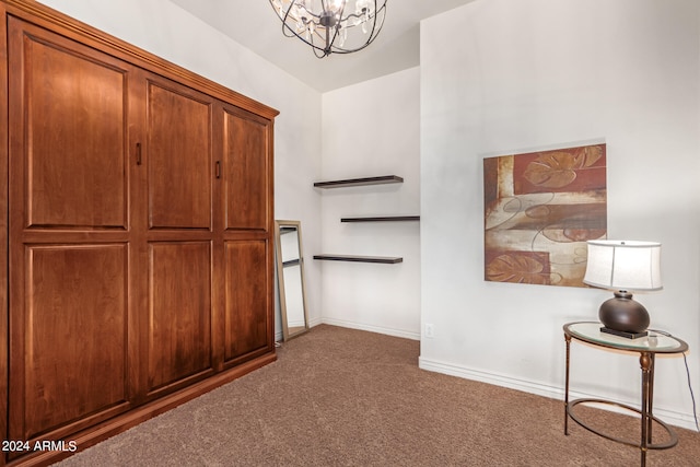 interior space featuring a chandelier and dark colored carpet