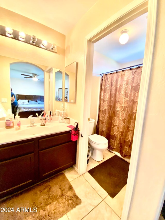 bathroom featuring vanity, toilet, tile patterned floors, and ceiling fan