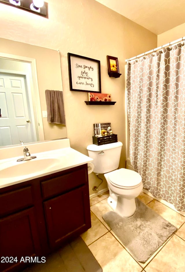 bathroom with vanity, a shower with curtain, toilet, and tile patterned floors