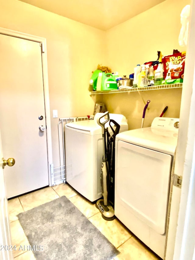 laundry area featuring washer and clothes dryer and tile patterned flooring