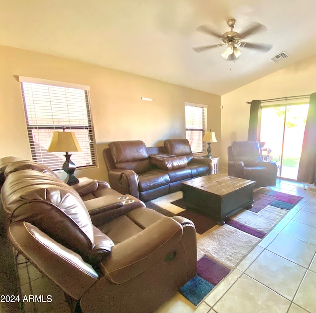 living room featuring ceiling fan, light tile patterned flooring, and vaulted ceiling