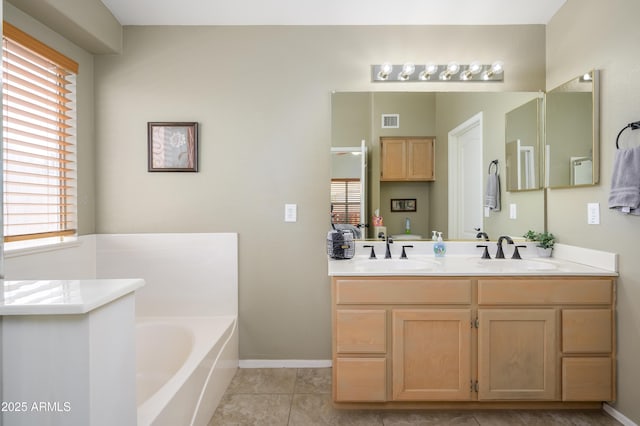 8331 E Plata Ave, Mesa, AZ 85212 - bathroom with visible vents, a healthy amount of sunlight, a garden tub, and a sink