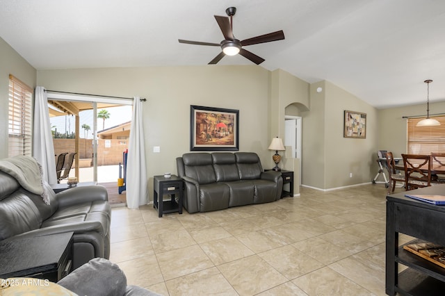 8331 E Plata Ave, Mesa, AZ 85212 - living room with light tile patterned floors, ceiling fan, baseboards, arched walkways, and lofted ceiling