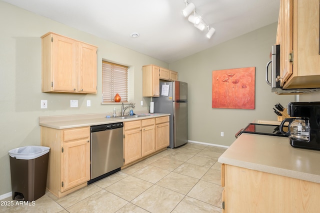 8331 E Plata Ave, Mesa, AZ 85212 - kitchen with light brown cabinetry, stainless steel appliances, vaulted ceiling, and a sink