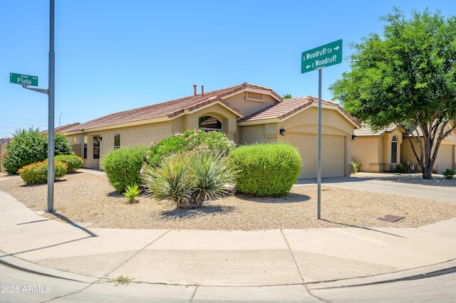 8331 E Plata Ave, Mesa, AZ 85212 - view of front of house featuring stucco siding, concrete driveway, a tile roof, and a garage