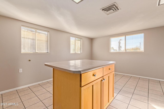 kitchen with visible vents, baseboards, and light tile patterned flooring