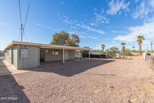 rear view of property featuring fence