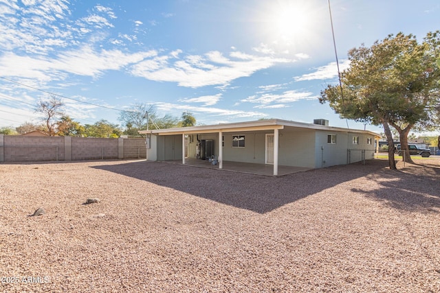 rear view of house with a patio and a fenced backyard