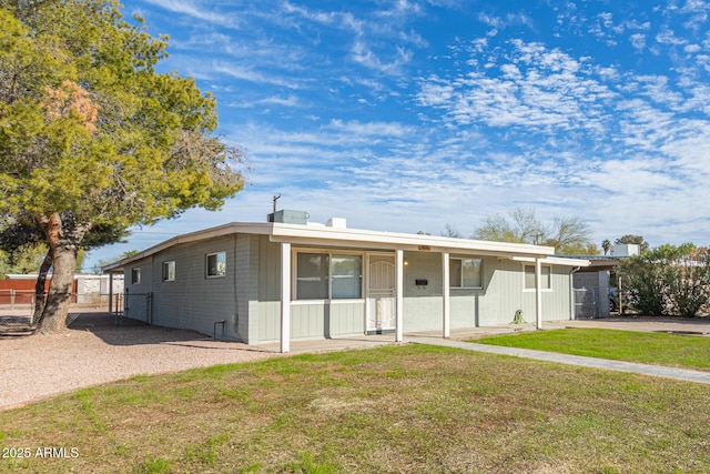 view of front of house featuring fence and a front lawn