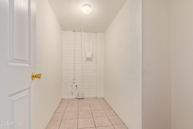 interior space with a textured ceiling and tile patterned floors