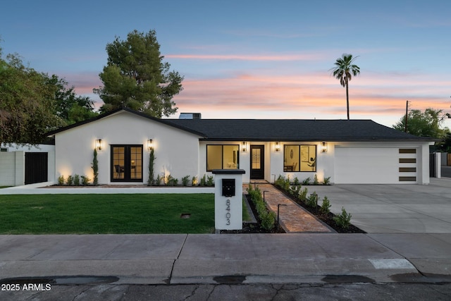 8403 E Fairmount Ave, Scottsdale, AZ 85251 - view of front of house featuring french doors, an attached garage, a front yard, stucco siding, and concrete driveway