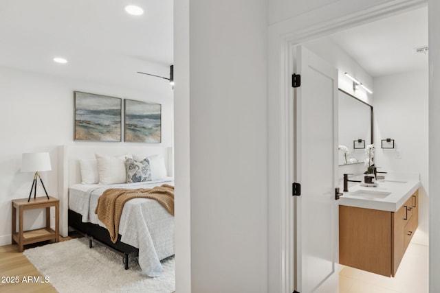 8403 E Fairmount Ave, Scottsdale, AZ 85251 - bedroom with a sink, light wood-style flooring, and recessed lighting