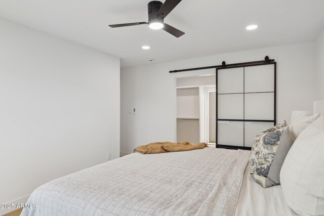 8403 E Fairmount Ave, Scottsdale, AZ 85251 - bedroom with a barn door, recessed lighting, and ceiling fan