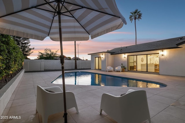 8403 E Fairmount Ave, Scottsdale, AZ 85251 - pool at dusk featuring a patio area and a fenced backyard